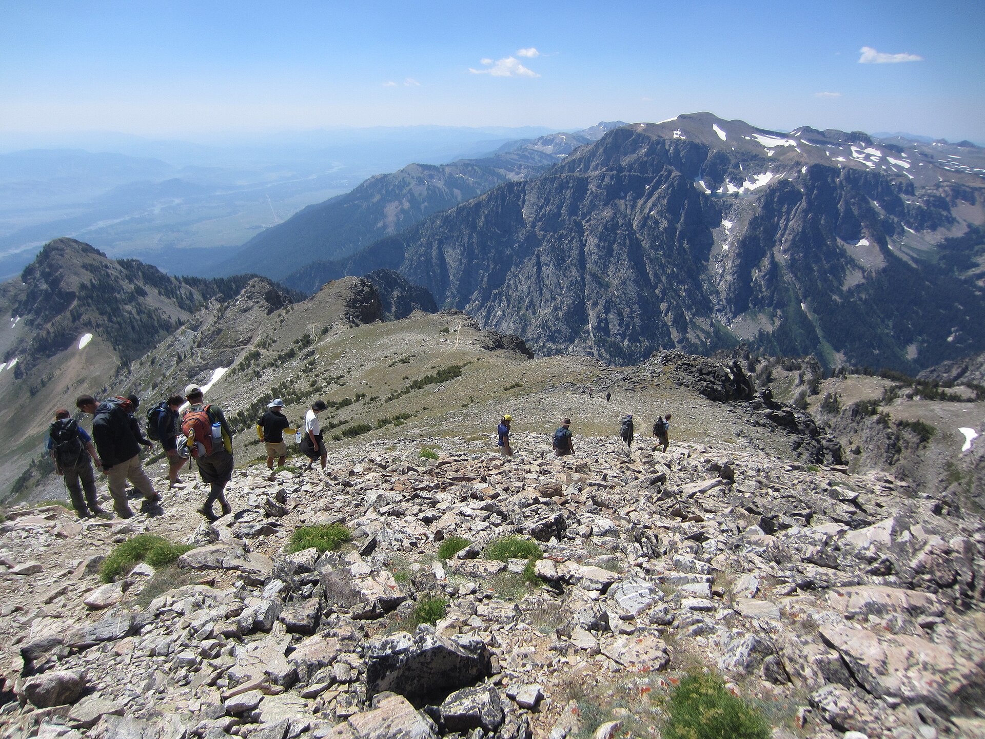 NPS Photo · Public domain · https://commons.wikimedia.org/wiki/File:Hikers_descend_an_alpine_trail_(Grand_Teton_NP)_(3d0b060b-1dd8-b71b-0b14-55a4b73c17c7).JPG · https://commons.wikimedia.org/wiki/File:Hikers_descend_an_alpine_trail_(Grand_Teton_NP)_(3d0b060b-1dd8-b71b-0b14-55a4b73c17c7).JPG A walking group on an Alpine trail in Grand Teton National Park