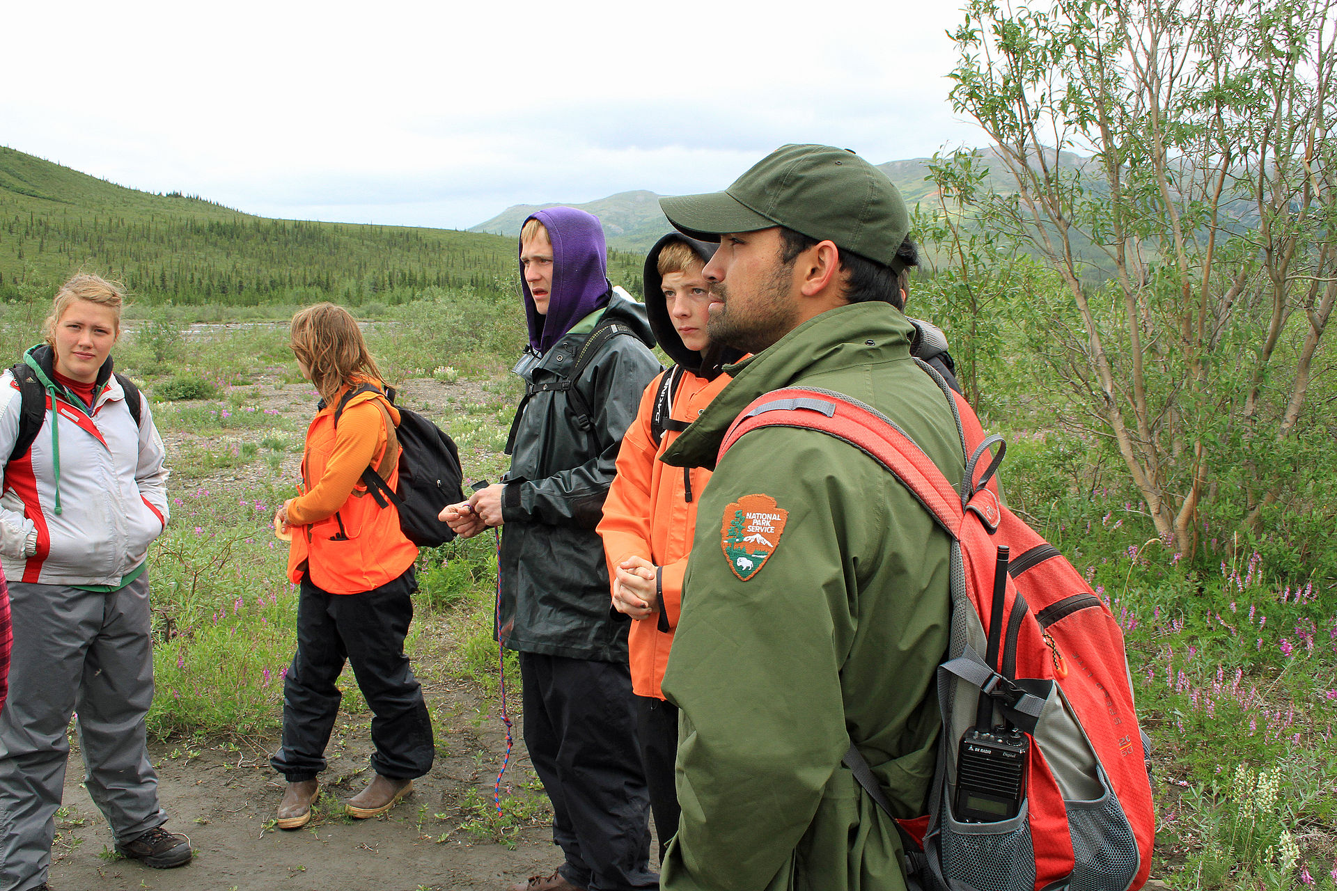 Denali National Park and Preserve · Public domain · https://commons.wikimedia.org/wiki/File:Kids_Camp_in_Denali_(8572664318).jpg · https://commons.wikimedia.org/wiki/File:Kids_Camp_in_Denali_(8572664318).jpg A ranger discussing an outdoor activity with a youth group in Denali
