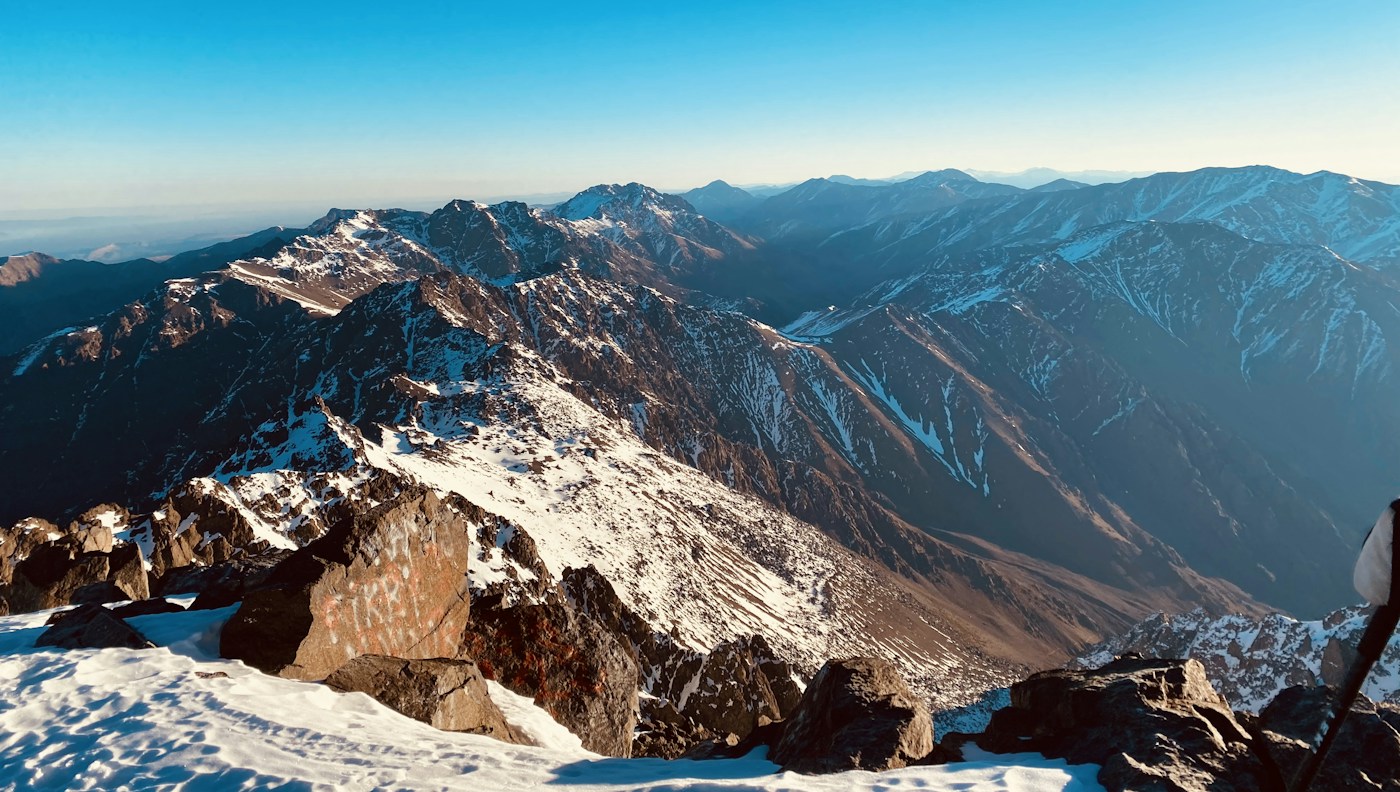 Unsplash License · https://unsplash.com/license · https://images.unsplash.com/photo-1611859836043-a9177f500a27 Snow-covered summit terrain on Toubkal in the Atlas Mountains
