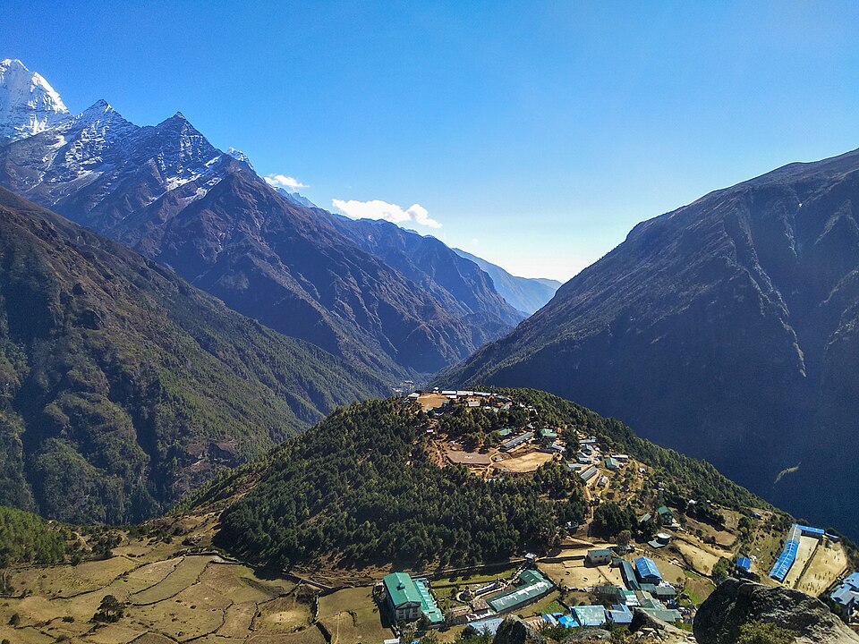 Rohit Sharma · CC BY-SA 4.0 · https://creativecommons.org/licenses/by-sa/4.0 · https://commons.wikimedia.org/wiki/File:Namche_Bazaar_from_Hotel_Everest_View_trail.jpg · Displayed with a crop to fit Namche from the Everest View trail