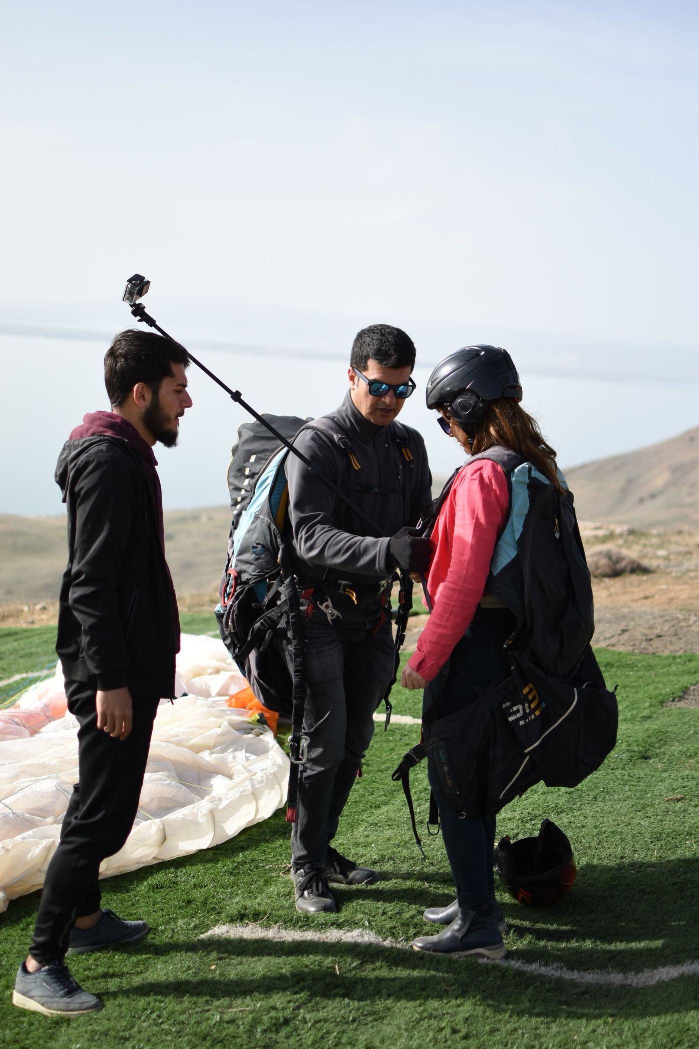 Rojda · Pexels License · https://www.pexels.com/license/ · https://www.pexels.com/photo/11787313/ An instructor checking a participant’s paragliding equipment before flight