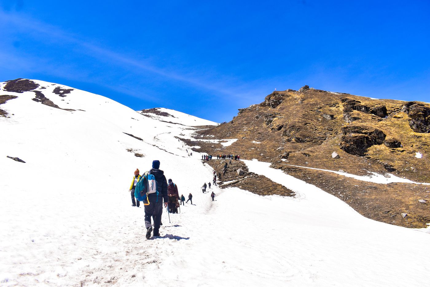 A trekking party travelling along a snow-covered mountain route