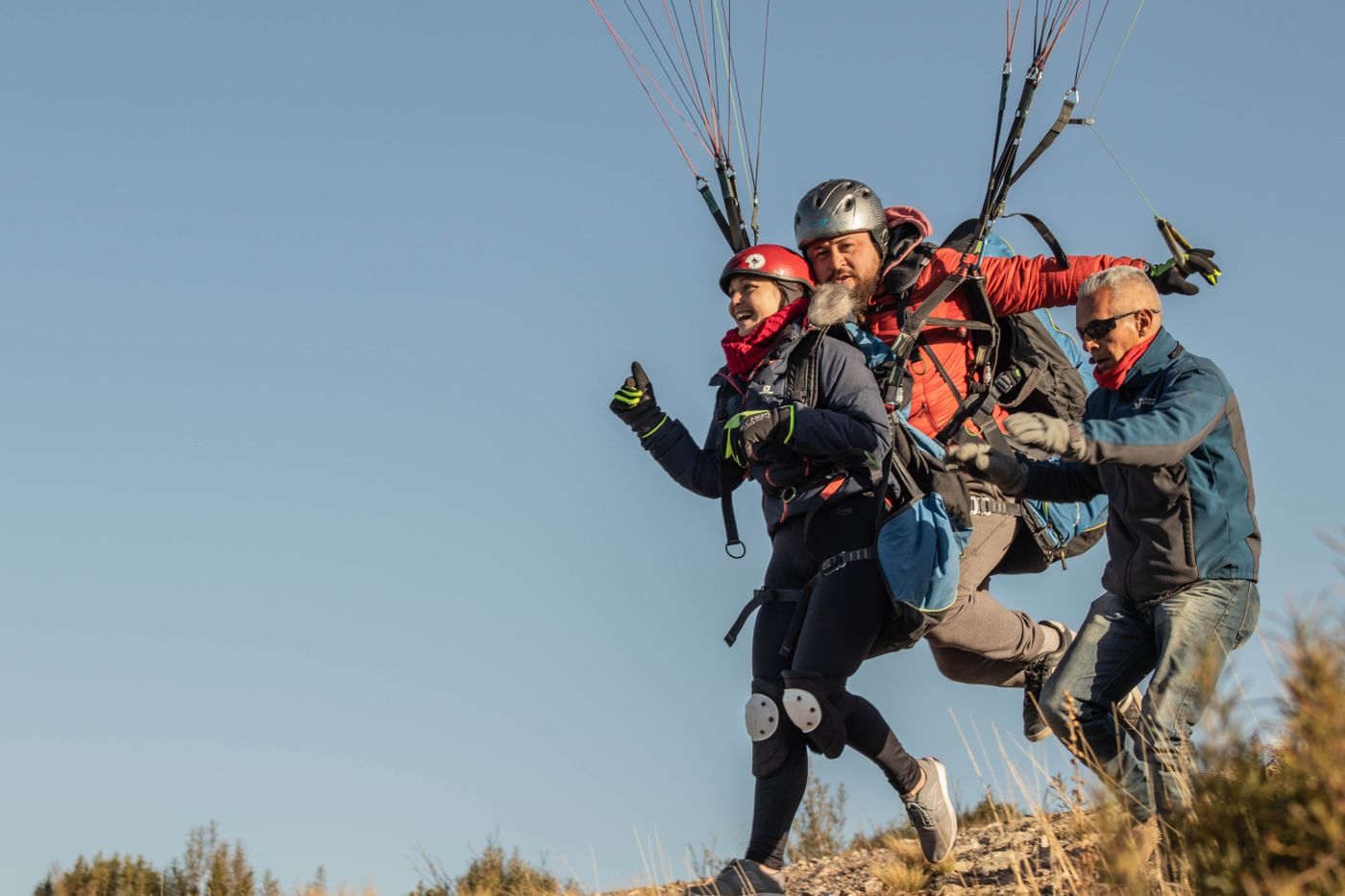 eduardo oscar · Pexels License · https://www.pexels.com/license/ · https://www.pexels.com/photo/4338055/ An instructor assisting a tandem paragliding pair during launch