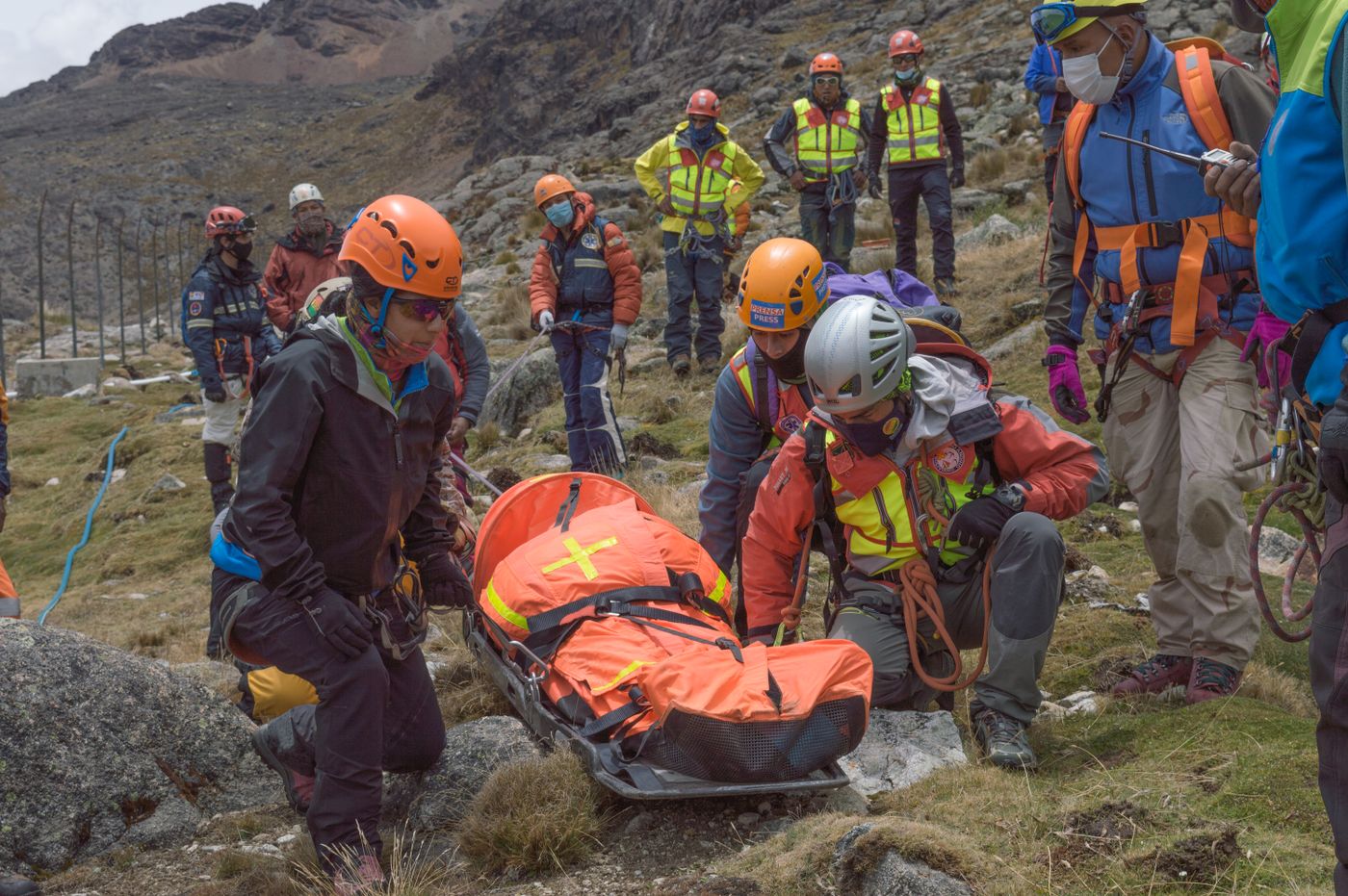 Roman Apaza · Pexels License · https://www.pexels.com/license/ · https://www.pexels.com/photo/9410628/ Mountain rescue personnel attending to a casualty on rocky terrain