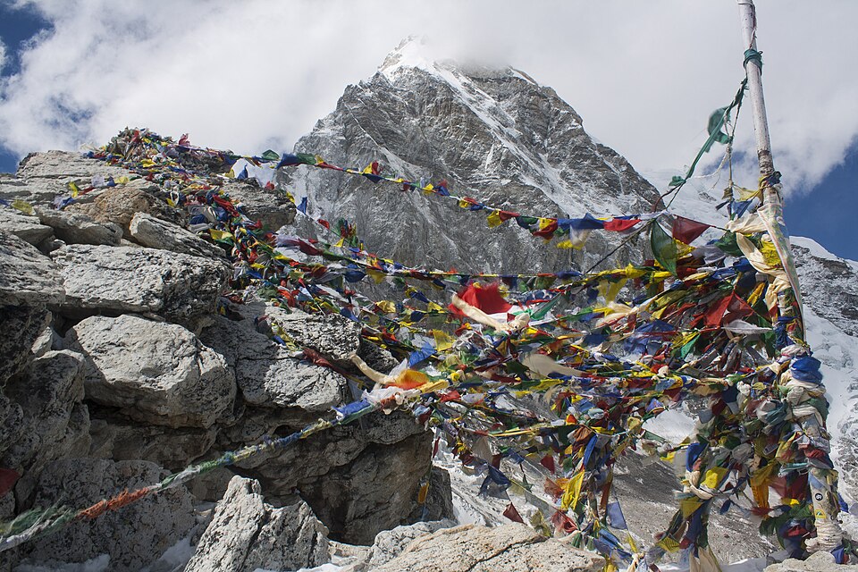 Prayer flags covering the rocky summit of Kala Patthar, Nepal