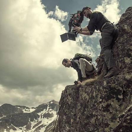 Activity reference photograph supplied for the SOOM website A camera operator and climbing partner working at a mountain rock face