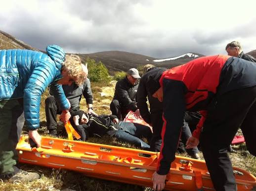 A group practising casualty handling with a mountain stretcher