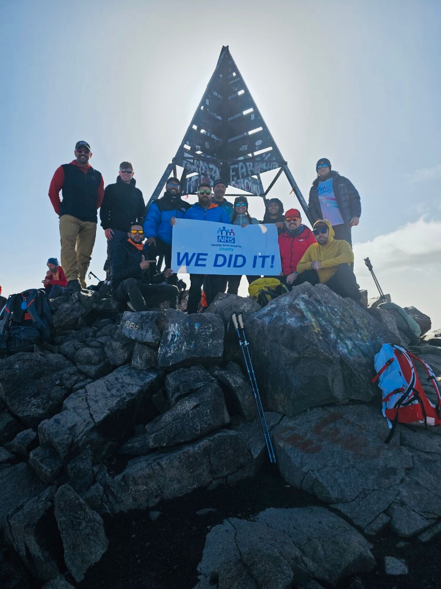 Activity reference photograph supplied for the SOOM website A healthcare charity group with an NHS charity banner at the Toubkal summit